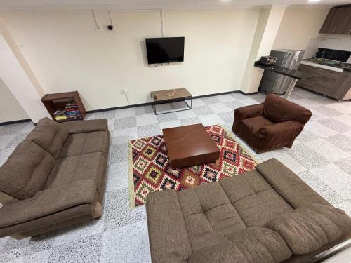 a living room with two couches and a tv at Apartamento Jaime Rook in Paipa