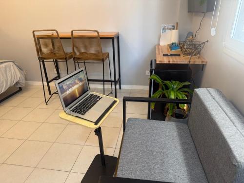 a laptop sitting on a stand in a living room at Blue Ocean in Mar del Plata