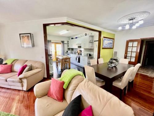 a living room with couches and a table and a kitchen at Apartamento da Torre in Mondim de Basto