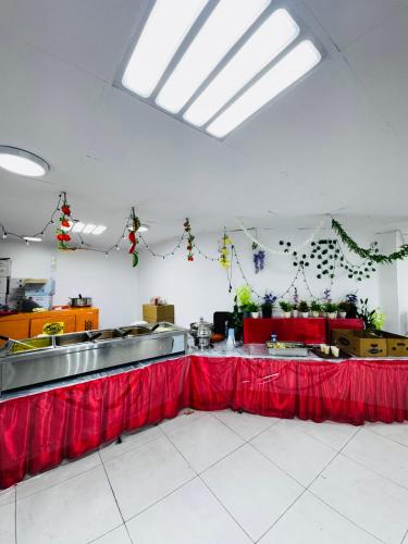 a kitchen with a red table in a room at Asraar Al Gharbia Ajyad Hotel Makkah in Makkah