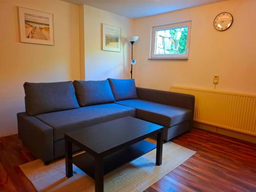 a living room with a blue couch and a table at Gemütliches Apartment in Giengen an der Brenz