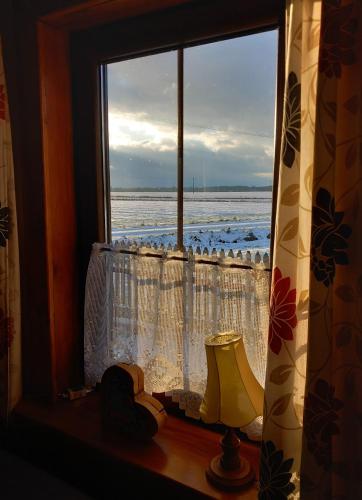 a window with a view of the ocean from a room at Dom na końcu wsi in Burzec