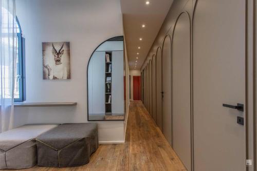 a hallway with a bed and a mirror on the wall at Luxury House In Bologna Marchesana 150 mq in Bologna