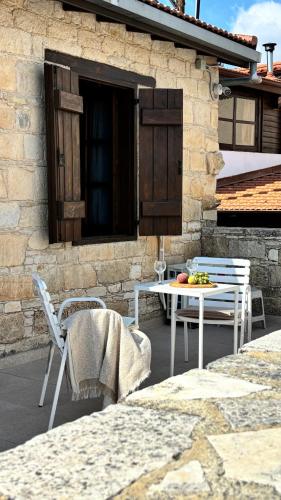 a patio with chairs and a table with fruit on it at Levanda House - Traditional House in Vasa Kilaniou