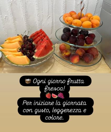 two tiers of fruit on plates on a table at Almà in Torre delle Stelle