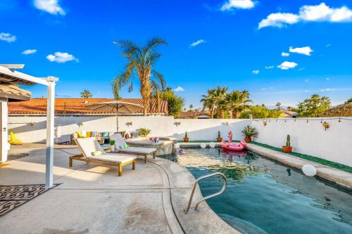 an outdoor swimming pool with chairs and a swimming pool noodle at Desert Fun 5BR Retreat with Pool in Bermuda Dunes