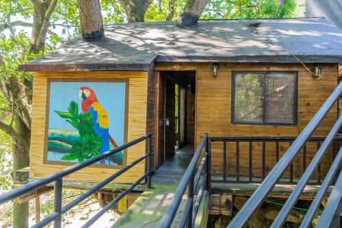 a house with a mural of a parrot on the door at Villa Fátima Ecohostal in Calabazo
