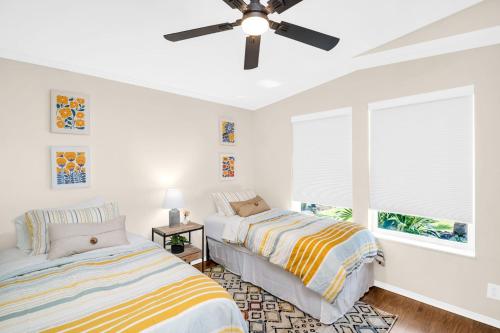 a bedroom with two beds and a ceiling fan at Walk to Blue Jays, Breweries, Marina & Beaches in Dunedin
