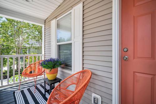 a porch with three chairs and a red door at Walk to Blue Jays, Breweries, Marina & Beaches in Dunedin