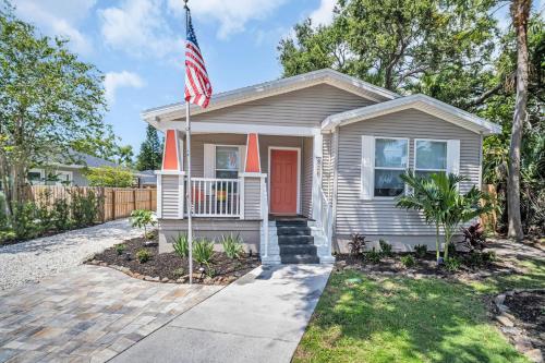 a house with an american flag in front of it at Walk to Blue Jays, Breweries, Marina & Beaches in Dunedin