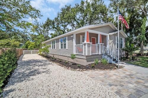 a small house with an american flag in front of it at Walk to Blue Jays, Breweries, Marina & Beaches in Dunedin