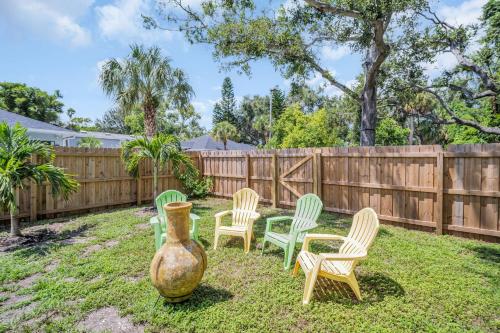 a yard with four chairs and a vase at Walk to Blue Jays, Breweries, Marina & Beaches in Dunedin