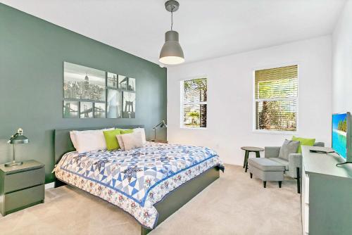 a bedroom with a bed and a desk and a chair at UPSTAY- 10BR Mansion wPrivate Pool and Games Room in Kissimmee