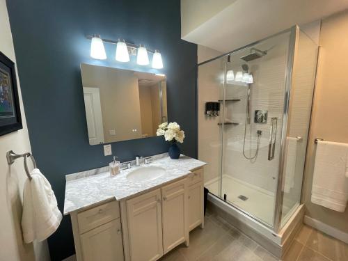 a bathroom with a sink and a shower at 2 Rivers Inn The Thousand Islands - LUXURY WATERFRONT WALKOUT in Gananoque