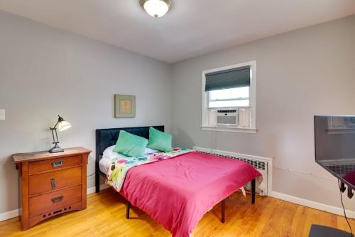 a bedroom with a bed and a dresser and a television at The Vault Your Fun Secured in Hillside