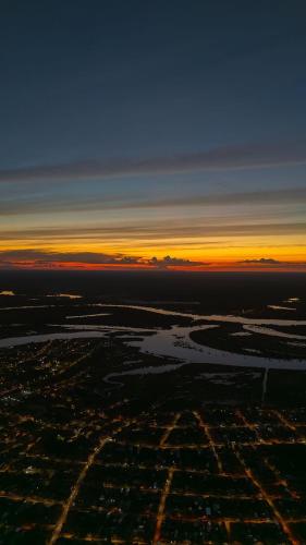 an aerial view of a city at sunset at Guacamayo Azul in Iquitos