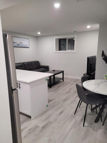 a living room with a couch and a table at Coastal Comforts Villa in Airdrie
