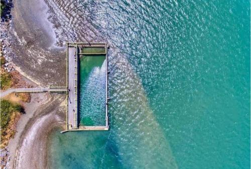 an aerial view of a bridge over the water at Sunny flat 5 minute walk to town in Motueka