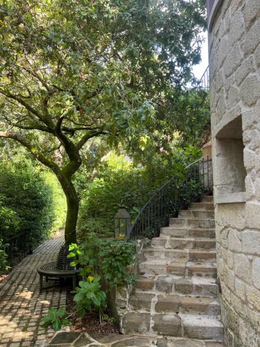 a stone stairway with a bench and a tree at Enoturismo Novavila Rias Baixas Wine Design in Meis