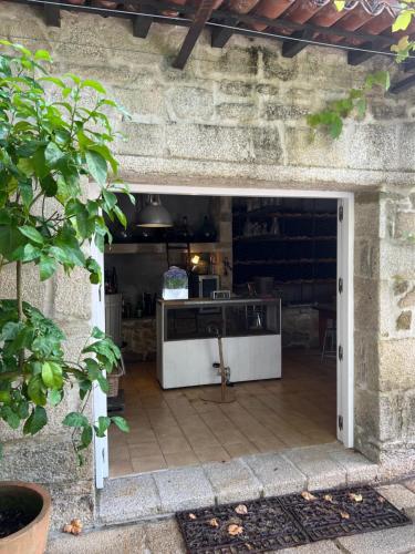 an open door into a patio with a table at Enoturismo Novavila Rias Baixas Wine Design in Meis