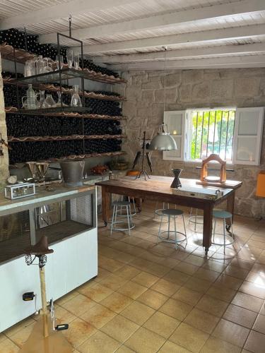 a kitchen with a wooden table in a room at Enoturismo Novavila Rias Baixas Wine Design in Meis