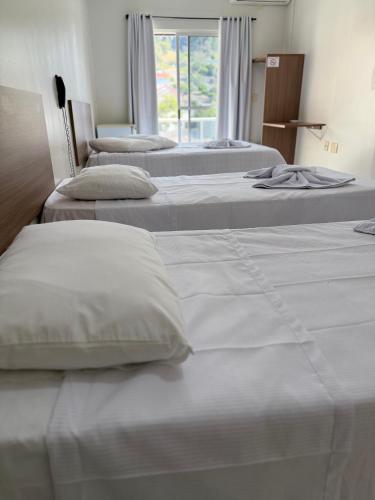 Ένα ή περισσότερα κρεβάτια σε δωμάτιο στο Hotel Ideal Beltrão