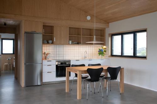 a kitchen with a table and chairs and a refrigerator at Barrio del Norte in Villademoros