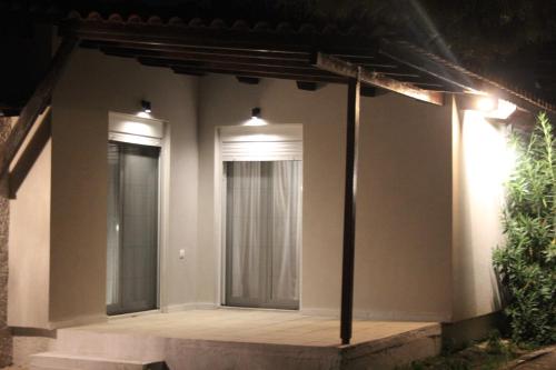 a room with two windows on a house at night at Sea Breeze in Kato Achaia
