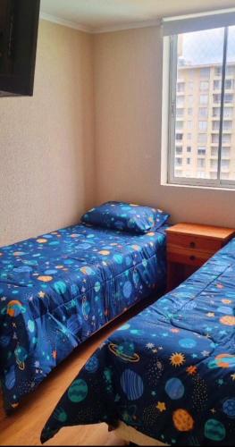 a bedroom with two beds and a window at Vista velero in Algarrobo