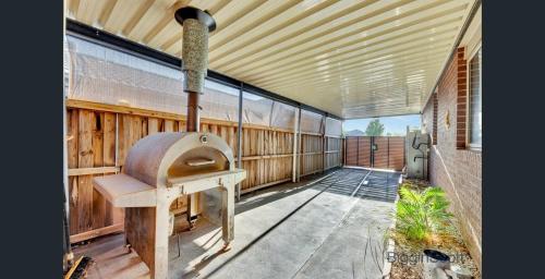 a porch with an outdoor oven on the side of a building at Tarneit Treasure in Tarneit