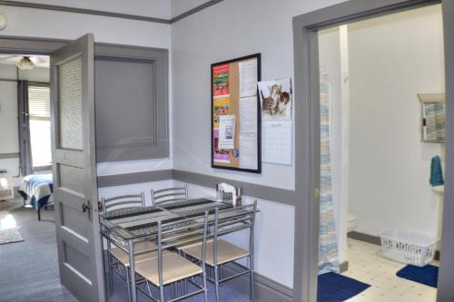 a room with two chairs and a glass table at K3 2nd Floor Studio Stay, Eat, Drink, MTU, Keweenaw 