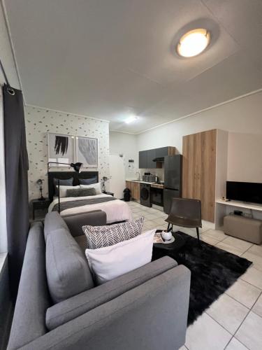 a living room with a couch and a bed at The Lagoon in Pretoria