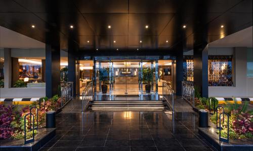 a lobby of a building with stairs and plants at فندق فيو الشاطي - Beach View Hotel in Dammam