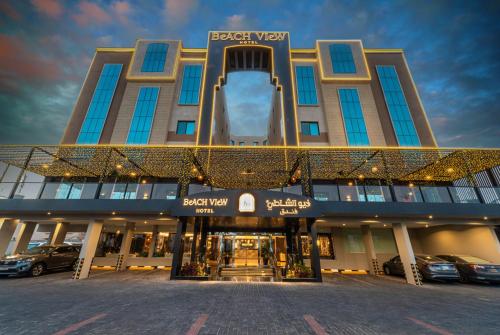 a building with cars parked in front of it at فندق فيو الشاطي - Beach View Hotel in Dammam