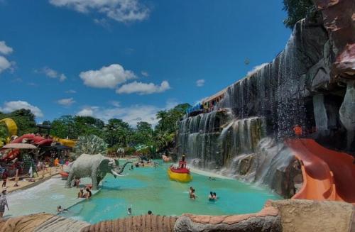 a waterfall at a water park with people in it at Alojamiento Sol Naciente in Puerto Triunfo