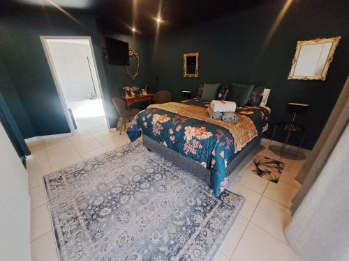 a bedroom with a bed and a rug at Dragonfly in Boksburg