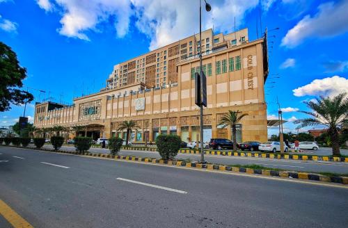 a large building on the side of a road at Goldcrest Mall & Residency - Luxury 1bhk, 2bhk, 3bhk Apartments in DHA Lahore in Lahore