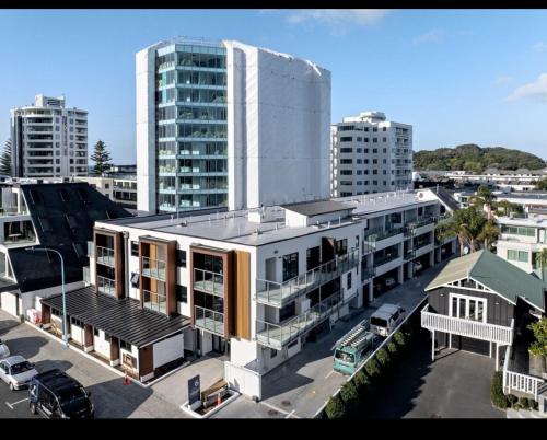 an overhead view of a large white building in a city at Beach escape at Mount Maunganui in Mount Maunganui