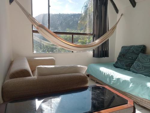 a living room with a couch and a window at Melgar Casa Piedras del Agua in Estación El Salto