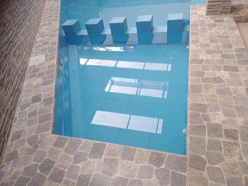 a swimming pool in a building with blue water at Gran Hotel Virrey in San Ramón