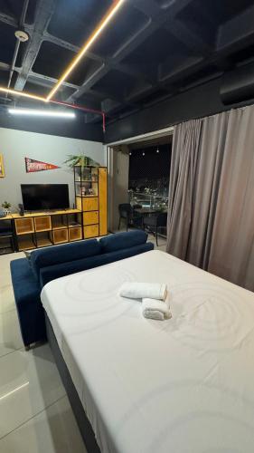 a bedroom with a bed with two towels on it at Apartamento moderno e completo no shopping DF Plaza in Brasilia