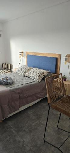 a bedroom with a bed and a chair and a table at Conesa Suite in General Sarmiento