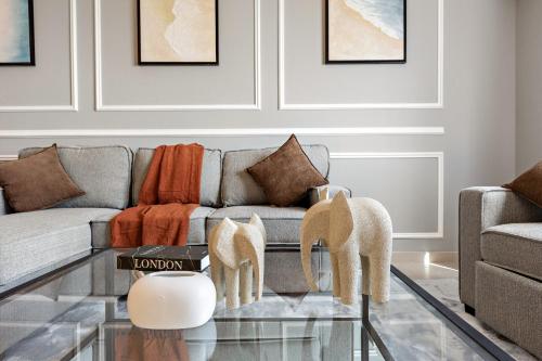 a living room with a couch and a glass table at Desert Key - Platinum Apartments in Gate Tower, Al Reem Island in Abu Dhabi