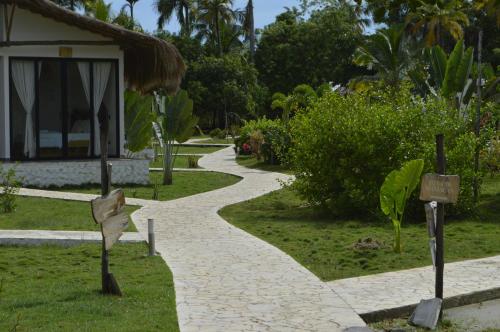a walkway in front of a building in a garden at Coral De Fuego Isla Fuerte in Isla Fuerte