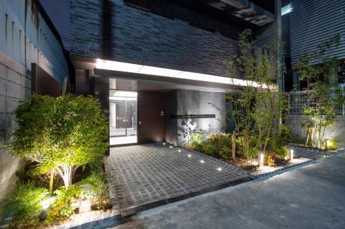 a building with a courtyard with trees and plants at CLASS Shinagawa in Tokyo