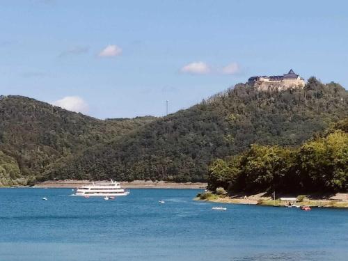 a boat in the water with a castle on a hill at Nele Daniel family in Waldeck