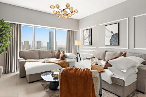 a living room with a couch and a table at Desert Key - Platinum Apartments in Gate Tower, Al Reem Island in Abu Dhabi
