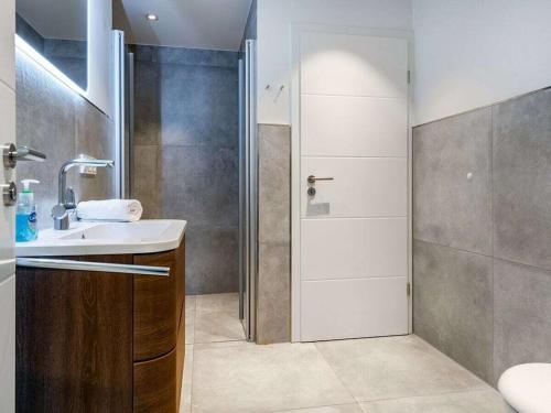 a bathroom with a sink and a shower at Holiday apartment with 2 bedrooms in Greetsiel