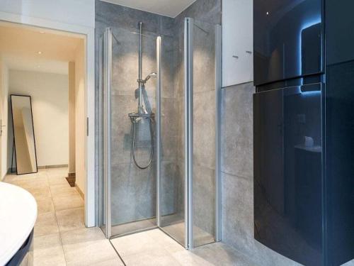 a bathroom with a shower with a glass door at Holiday apartment with 2 bedrooms in Greetsiel