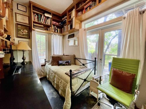 a bedroom with a bed and a window and a chair at The Rivery Retreat, Choose from Luxury Guesthouse Cabin OR Poolside Suite in Lake Austin Hill Country in Austin